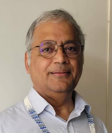 Portrait of Somendra Mohan Bhattacharjee wearing a lanyard by Saberi
